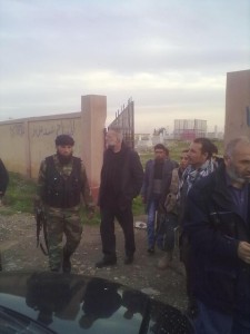Dall'Oglio visiting the cemetery in Tal Abiad, escorted by FSA fighters