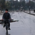 A child in Aleppo transports wood on a bicycle. Photo credit: Lens Young Halabi page on Facebook.