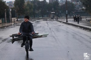A child in Aleppo transports wood on a bicycle. Photo credit: Lens Young Halabi page on Facebook.