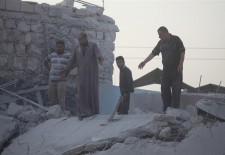 This man looks at what remains of his building.