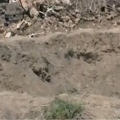 A large crater left by an air raid in the town of Bouleil in 2012 - YouTube/alfurat2freedom
