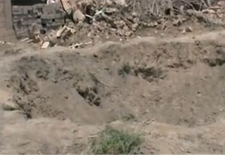 A large crater left by an air raid in the town of Bouleil in 2012 - YouTube/alfurat2freedom