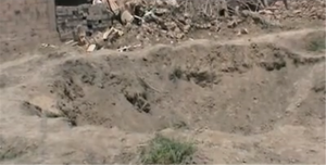 A large crater left by an air raid in the town of Bouleil in 2012 - YouTube/alfurat2freedom