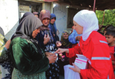 Internally displaced women receive medication from the Syrian Red Crescent. Photo credit: Enab Baladi