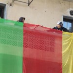 People raise the Kurdish flag on their balconies to celebrate the liberation of Kobani.