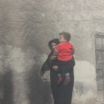 A woman carries her child out of her house that was struck by a shell in the Marja neigbourhood of Aleppo. Photographer: Salah al-Ashqar