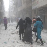 Women as evacuate their houses after an airstrike on the Ansari neighbourhood in Aleppo. Photographer: Baraa al-Halabi