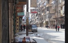 Wreckage of a public bus separates opposition-controlled areas from government-controlled areas in Aleppo. Photo: Salah al-Ashqar