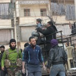 إحدى الصحفيات المواطنات تقوم بتصوير حالة لأسعاف طفل تعرض منزله للقصف في مدينة حلب;