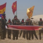 Soldiers carrying the banners of the various parties they belong to at home