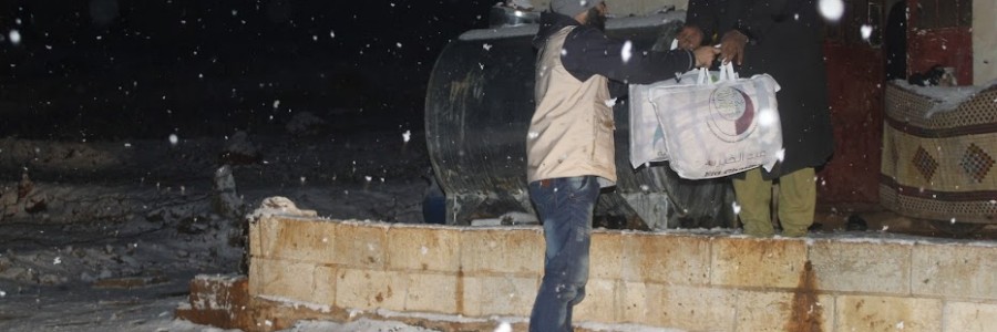 Aid is distributed to camp residents on a freezing cold day