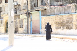 A woman in Aleppo’s Seif al-Dawla neighbourhood. Photo: Hussam Kuwaifatiyeh