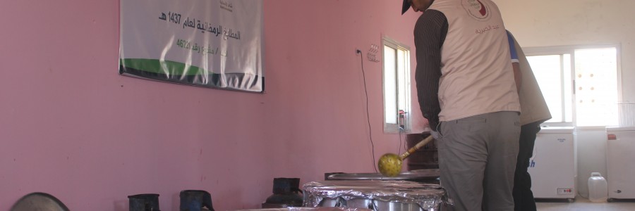 Young men busy cooking in a field kitchen